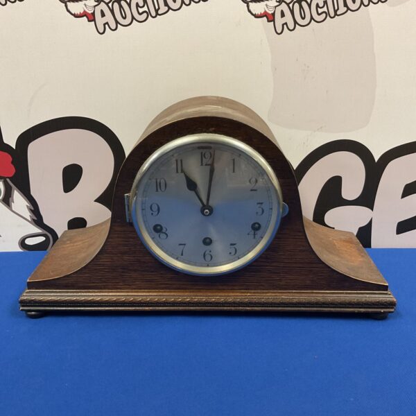 Vintage Napoleon hat mantle clock with circular dial.