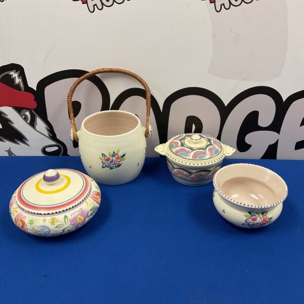 Vintage Poole Pottery Devonshire lidded pots and bowls on blue background.
