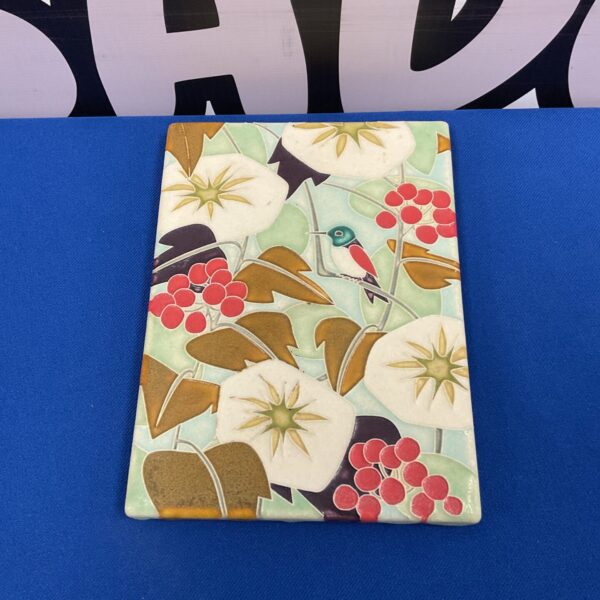 Vibrant Motawi Tileworks tile featuring a bird and berry design.