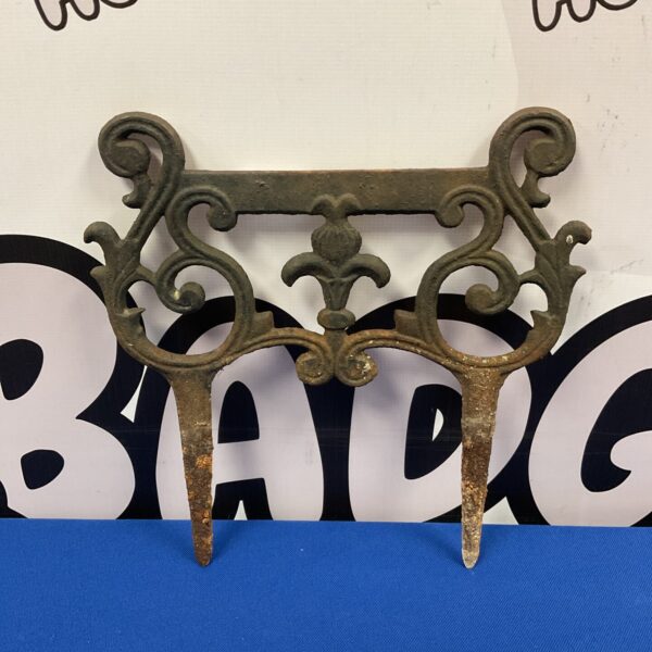Antique cast iron fleur de lis boot scraper for garden use.
