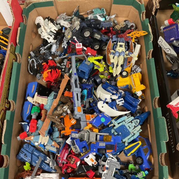 Mixed lot of vintage toy cars and action figures for collectors.