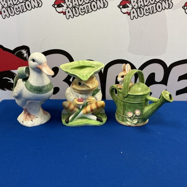 Vintage Beatrix Potter figurines of a duck, toad, and rabbit.