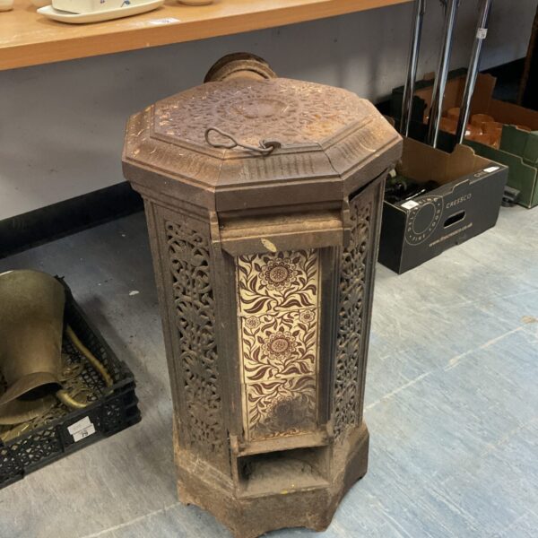 Intricate Victorian cast iron stove with pierced detailing.