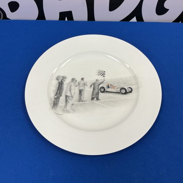 Vintage Goodwood racing plate with classic car depiction.
