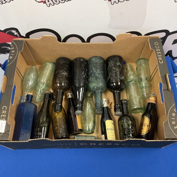 Vintage glass bottle collection with varied shapes and colours.