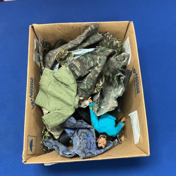 Vintage Action Man accessories and uniforms in a box.