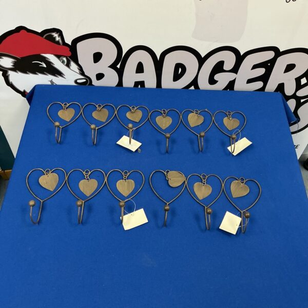 Vintage metal heart wall hooks for rustic decor.