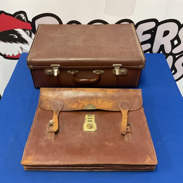 Vintage brown leather travel bag with buckle closure.