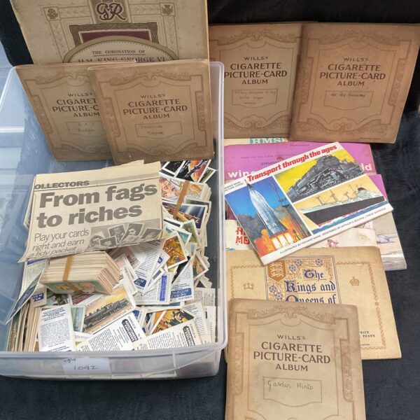Vintage cigarette card album collection, featuring various series and designs.