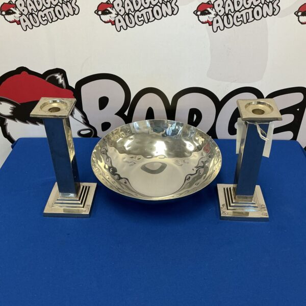 Polished nickel candle pillars with a metal fruit bowl centrepiece.