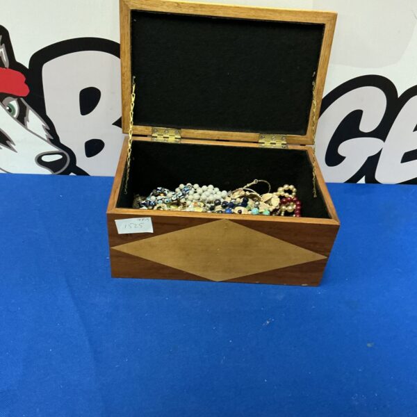 Vintage wooden jewellery box with beaded jewellery inside.