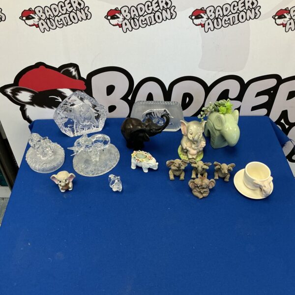 Vintage porcelain elephant figurine collection on display.