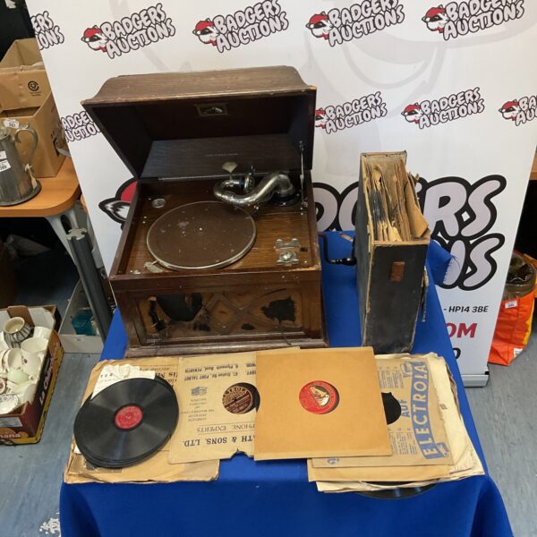 Vintage HMV gramophone with a collection of records for collectors.