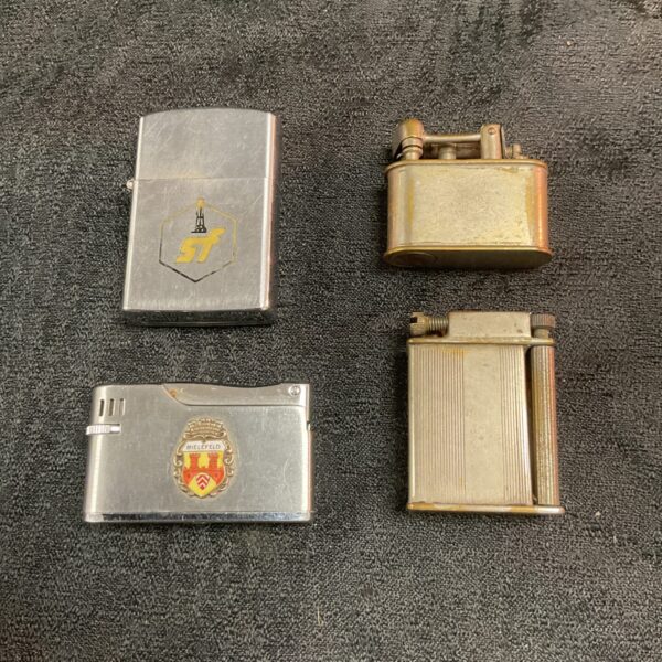 Vintage cigarette lighter with "SF" emblem, collectible metal lighter.