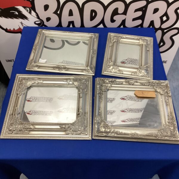 Lot of four silver effect framed mirrors with ornate frames.