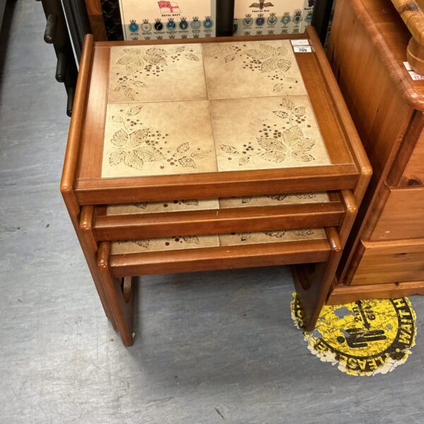 Vintage nest of three tile top occasional tables in wood.