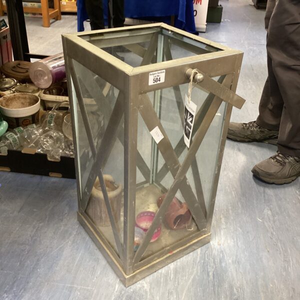 Large metal garden lantern with geometric design for outdoor lighting.