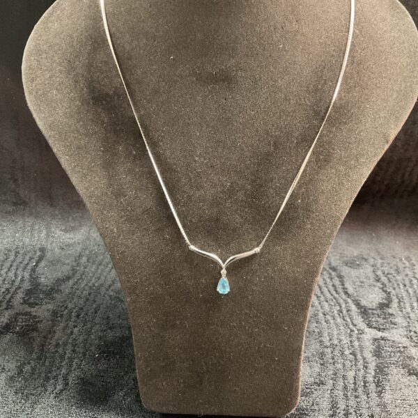Elegant 9ct white gold pendant with blue topaz and diamond.