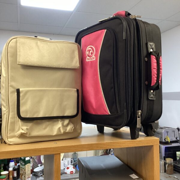 Pink Taylor childs suitcase and beige rucksack travel set.