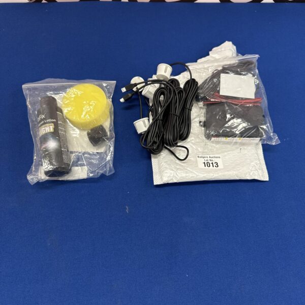 Headlight restoration kit with parking sensor components.
