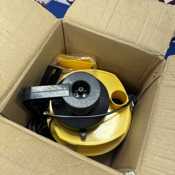 Yellow 12v car vacuum cleaner inside a cardboard box.