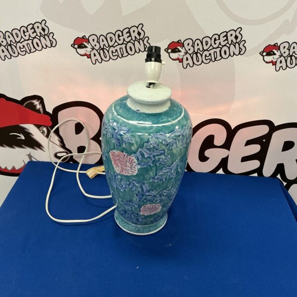 Vintage blue and white ceramic table lamp with floral design.