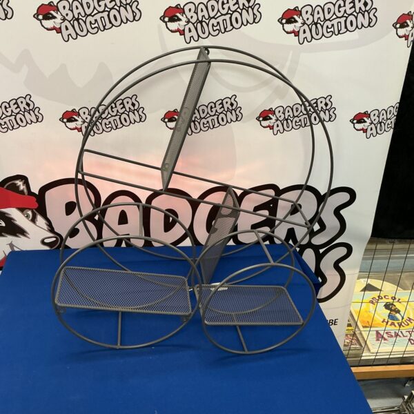 Vintage metal circular shelving unit with three tiers.
