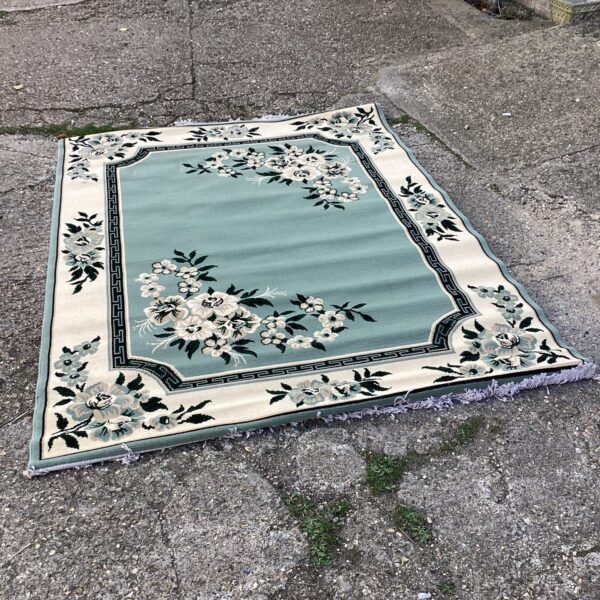 Detailed floral pattern on a 7ft x 5ft rug.