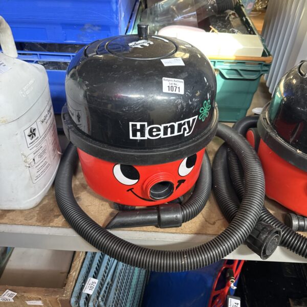 Red Numatic Henry Hoover, a classic cylinder vacuum cleaner.
