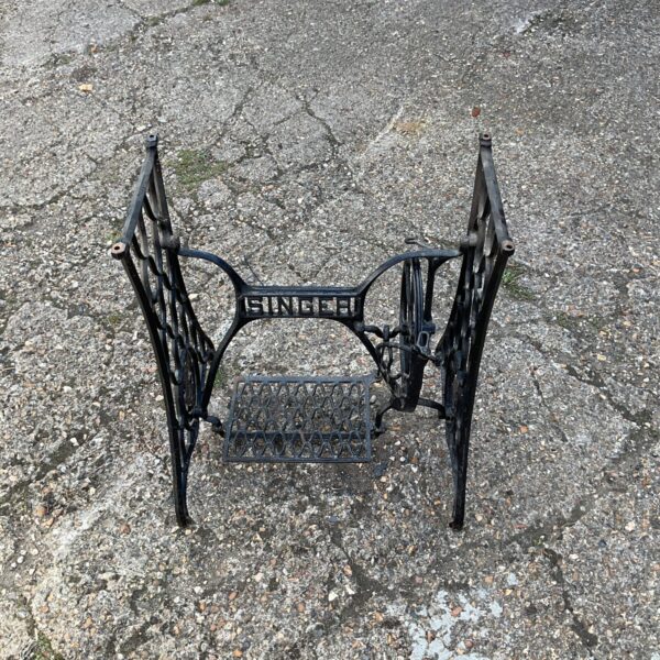 Vintage Singer treadle base with ornate cast iron detailing.