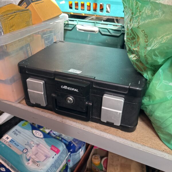 Front view of a grey Cathedral strong box with a locking mechanism.