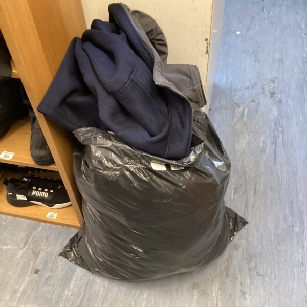 Mixed clothing lot with jackets and assorted garments.