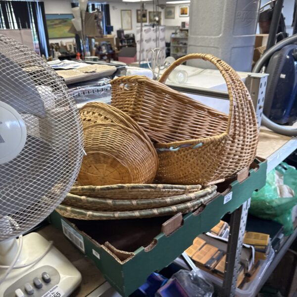 Assorted vintage wicker baskets for farmhouse decor and storage.