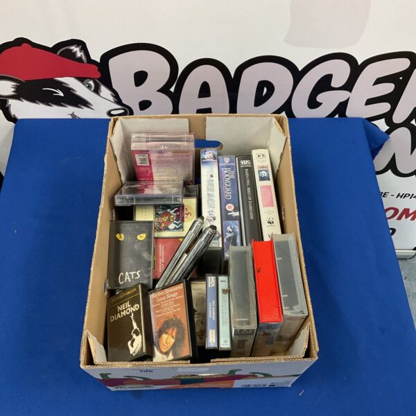VHS tape lot featuring Neil Diamond, Barbra Streisand, and movie titles.