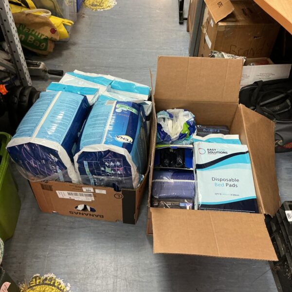 Two boxes of unopened Tena incontinence pants for adult care.