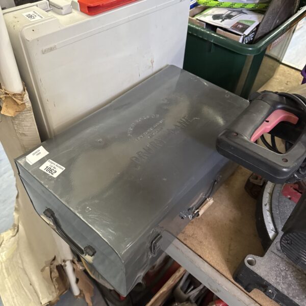 Vintage Drury Lane metal storage box with signs of wear.