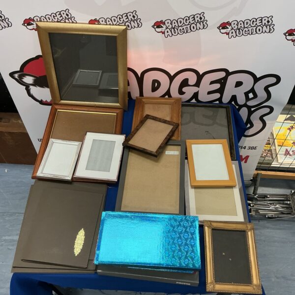 Mixed lot of new picture frames and photo albums for display.