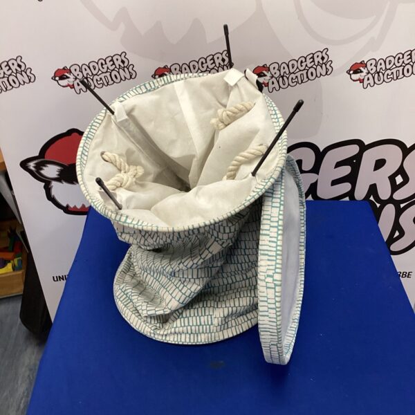 Patterned fabric wash bin with handles for laundry or storage.