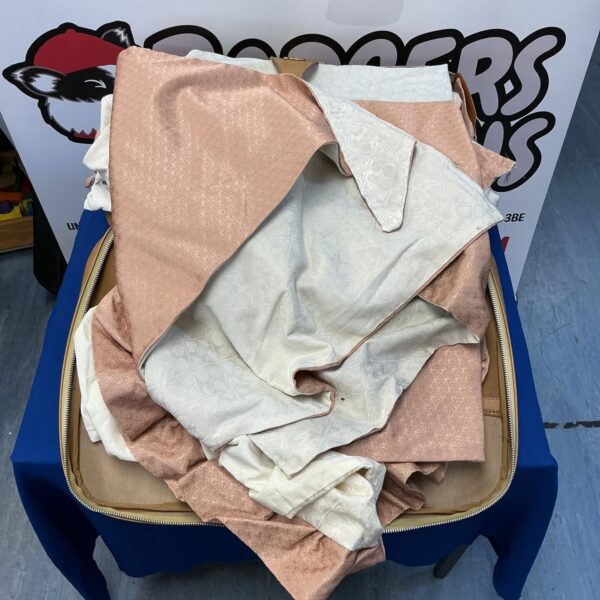 Large lot of colourful curtain material remnants for crafting.