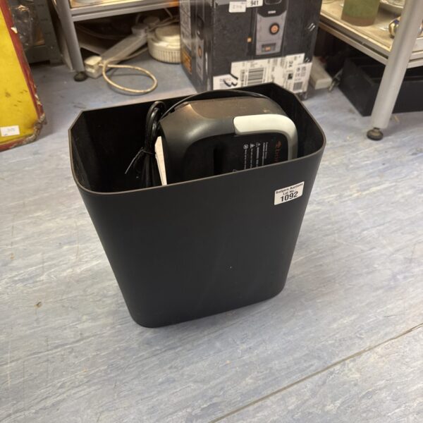 Black Bonsai small office paper shredder on a table.