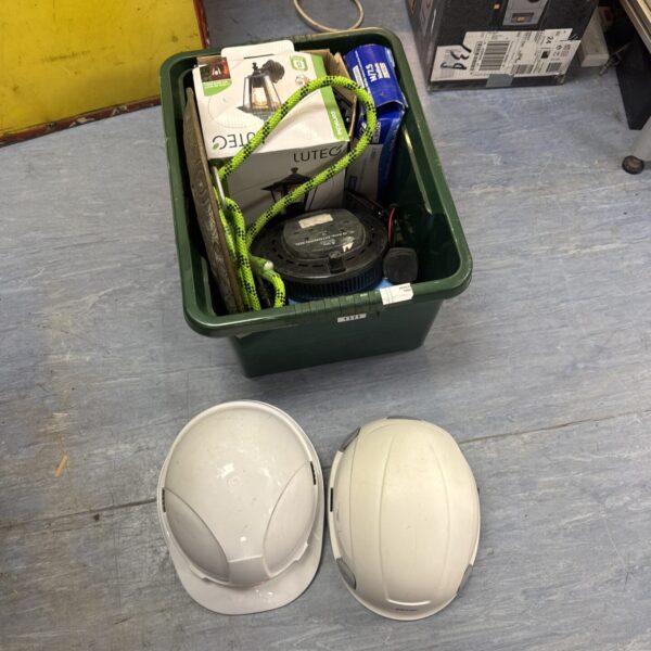 Mixed lot of tools and safety gear including hard hats and gloves.