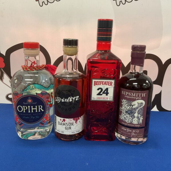Collection of four gin bottles, including Beefeater and Damson Gin.