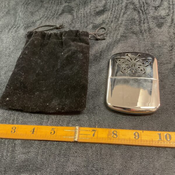 Chrome plated vintage catalytic hand warmer for outdoor use.