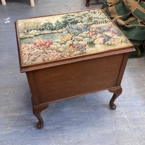 Vintage tapestry sewing stool with lift-top storage for needlework.