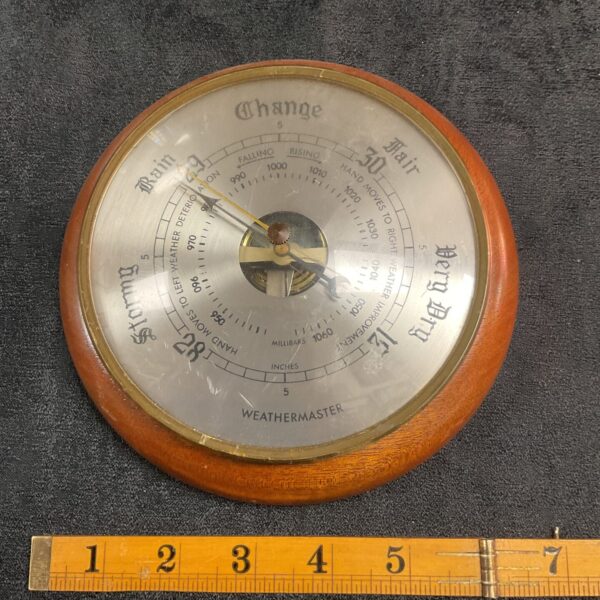Antique barometer with rain and fair weather indicators.