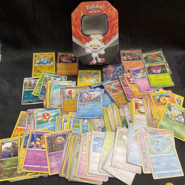 Large tin filled with a diverse Pokemon card collection for trading.