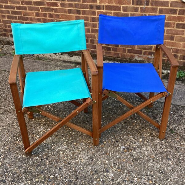 Two vintage director chairs with wooden frames and canvas seats.