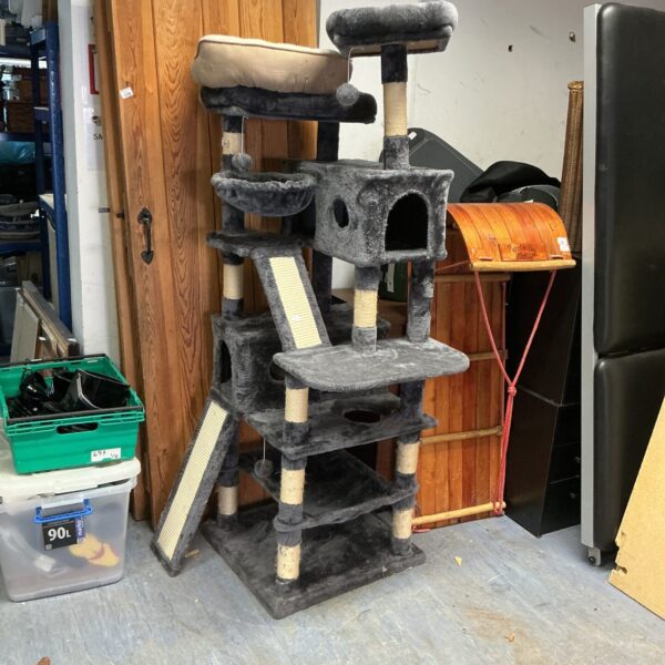 Multi-tiered cat climbing frame with plush carpeting and scratching posts.
