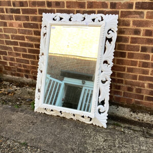 Large white Art Nouveau mirror with ornate floral detailing.