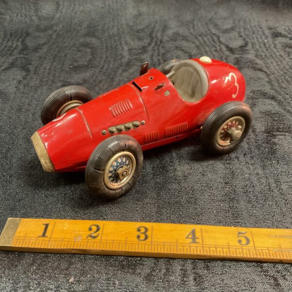Vintage Schuco Grand Prix Racer toy car, red tinplate, collectible.